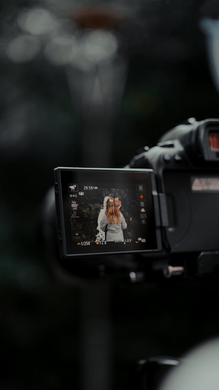 about-us Close-up of camera screen showing a couple during wedding photography outdoors.